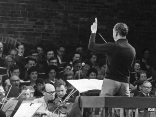 Conductor with orchestra in black and white